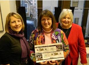 Harriet with Clare Ross and Mary Rasmussen, showing off the new Z. J. Loussac renovation plans