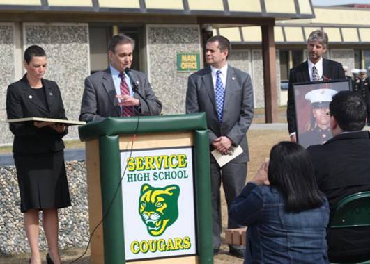 Representatives Chris Tuck and Charisse Millett join Senator Kevin Meyer in presenting a memoriam to the family of Corporal Gregory Fleury, in honor of his service to his country.